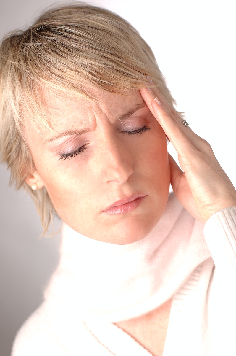 Woman holding her head in pain with headache